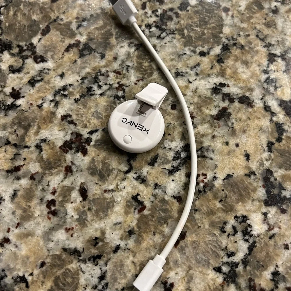 White Mini phone light with clip and  Charging Cable